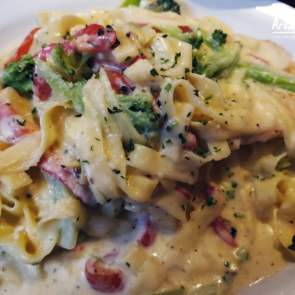 Creamy fettuccine pasta with broccoli, red peppers, and herbs from Arianna's Italian Grill Lakeside.